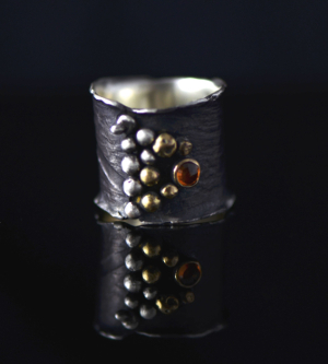 blackeded silver with red stone